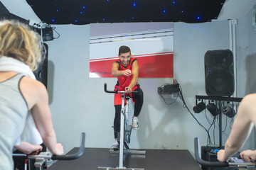 fit people in a spin class at the gym