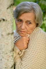 Portrait of a senior woman by the tree