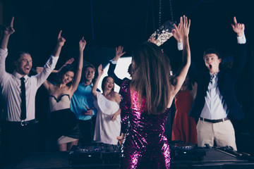 Nightlife concert concept. Dj stand back to the camera in front 