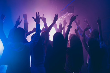 Fans rest, relax, chill waving raised hands cheering in night cl