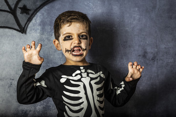 Naklejka premium Little kid in a skeleton costume on Halloween Carnival