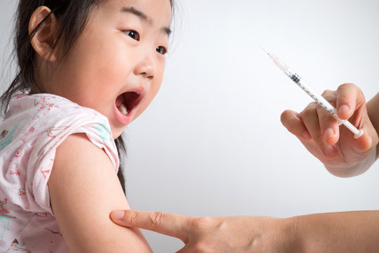 Distressed little girl getting an injection