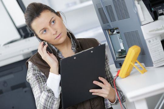 female researcher technician with clipboard and phone