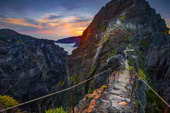 Madeira, Portugal. Hiking path between Pico do Arieiro and Pico do Ruivo at sunset above the clouds