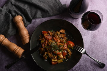 Hot spicy stew eggplant, sweet pepper, tomato and capers. Flat lay. Top view