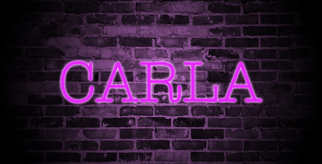 first name Carla in pink neon on brick wall