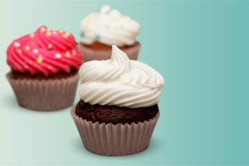 Tasty Colorful cupcakes on background