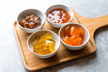 Various Ceramic bowl of Fruit jams Fig, Quince, Bergamot Citrus, Watermelon in wooden tray / Marmalade