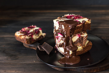 Chocolate cheesecake layered with brownie and dark cherrie. Chocolate cherrie cake. Pieces of...