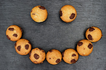 Chocolate chip muffins with smile face shape.