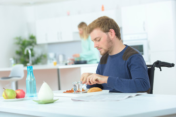 man disabled on wheelchair eating lunch