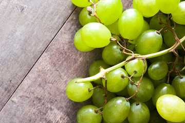 Green grapes on wooden table. Copyspace