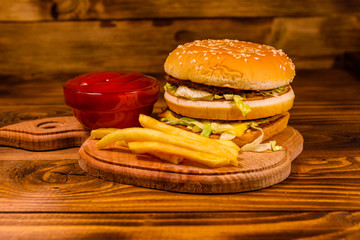 Hamburger and sauce on a wooden table