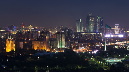 Elevated night view over the city center and central business district with bayterek Timelapse, Kazakhstan, Astana