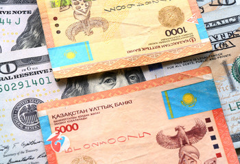 Kazakhstan tenge and dollars banknotes. Macro background on banking devaluation and the tenge to dollar exchange rate for bussiness sites, magazines and digital media.