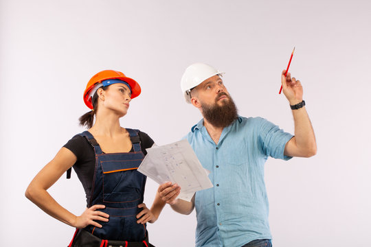 A male architect or engineer meeting with a building woman contractor on white background
