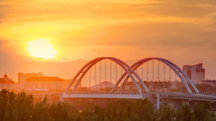 Sunset timelapse above the Bridge with the transport and clouds on the background. Central Asia, Kazakhstan, Astana