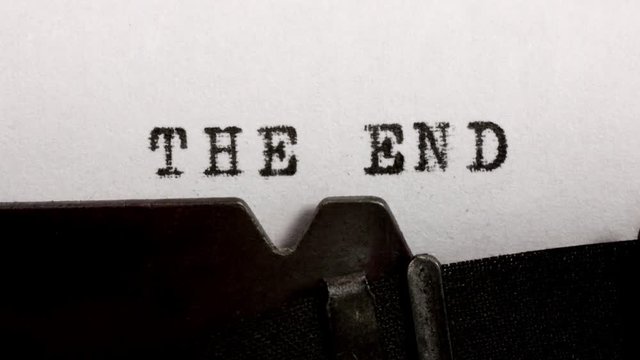 Typing THE END in black ink on an old mechanical typewriter.