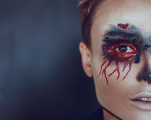 Portrait of a female vampire over black background