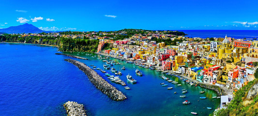 View of the Port of Corricella with lots of colorful houses on a sunny day in Procida Island, Italy.