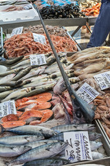 Naklejka premium Asprovalta, Greece - August 13, 2018: Selling fresh fish and squid on public market