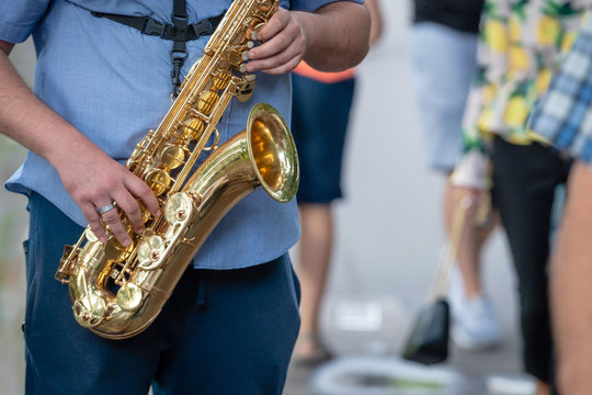 The street musician playing saxophone.