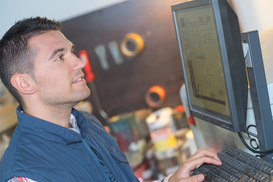 person at computer terminal in distribution warehouse