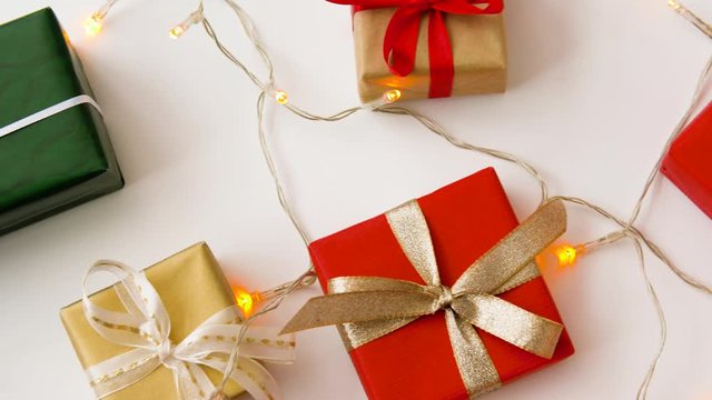 christmas and holidays concept - wrapped gifts set and garland string on white background