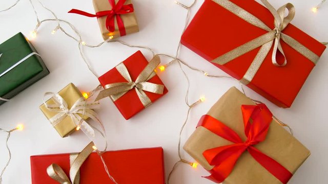 christmas and holidays concept - wrapped gifts set and garland string on white background