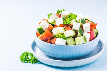 Cucumber feta tomato salad with olive oil dresssing. Selective focus, space for text.