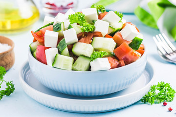 Cucumber feta tomato salad with olive oil dresssing. Selective focus, space for text.