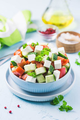 Cucumber feta tomato salad with olive oil dresssing. Selective focus, space for text.