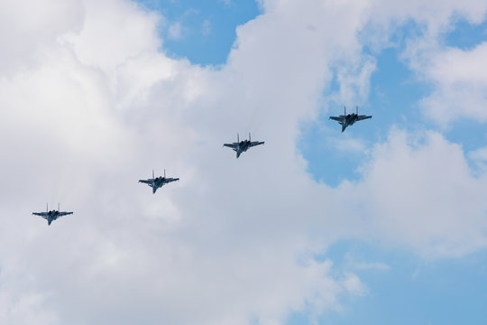 Military jet fighters fly away in the sky
