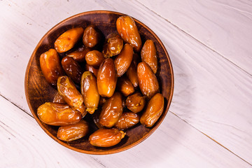 Date fruits on the white wooden table. Top view