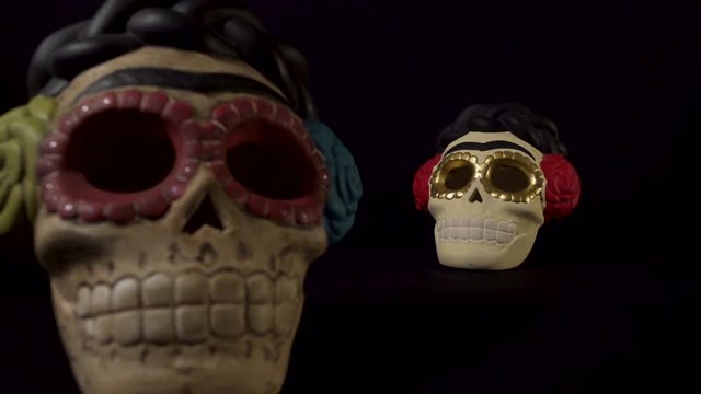 Two skuls with focus in and out in a black background for halloween