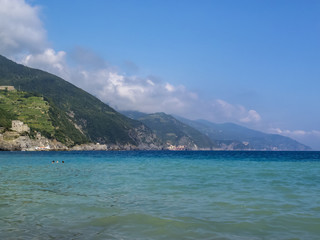 Fototapeta na wymiar Blue Mediterranean Sea view with cliffs and mountain hills at Monterosso al Mare, Cinque Terre, Italy