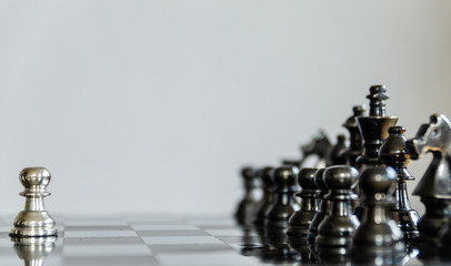 Detail of a hand making the first move in a chess game, moving the pawn one field forward....