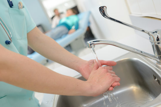 nurse washes hands