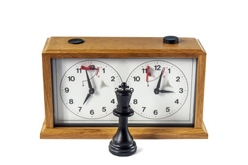 Wooden chess clock isolated on white background, black king standing in front at the center.