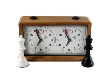 Chess clock isolated on white background, , black and white king standing in front at the sides.