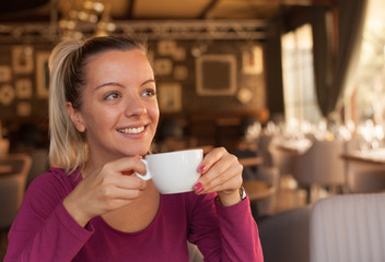 Happy young woman enjoying in morning coffee