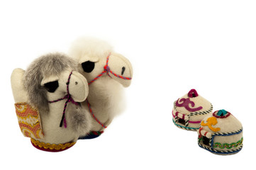 Two camel toys and two yurts on a white background. Isolated.