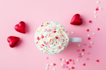 Romantic drink, coffee, latte, cappuccino with whipped cream. Top view. Pink background.