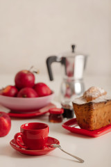 Breakfast - coffee and cupcake in a red bowl on a white background.