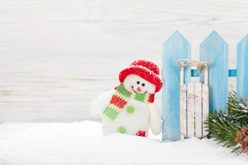 Christmas snowman and sledge toys and fir tree branch