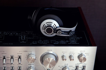 Audio Stereo Headphones on the top of Vintage Amplifier