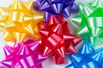 Pink,yellow,red,green,blue and purple gift wrap bows top closeup view on white background