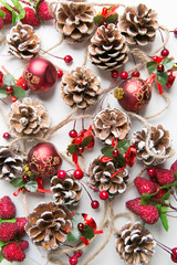 A top view of  mixed golden and red christmas ornaments on red background