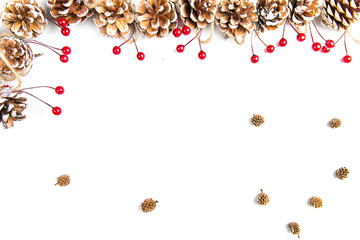 A top view of a christmas ornaments: pine cones awith red berries on white background