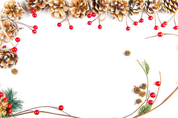 A top view of a christmas ornaments: pine cones awith red berries, curved twigs and pine needles on white background